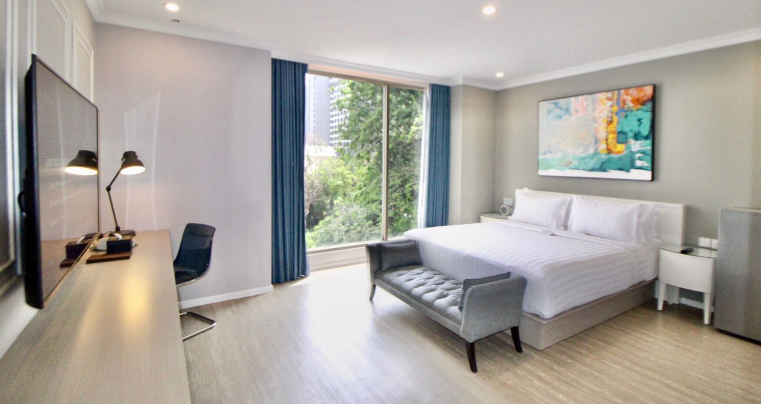 A modern hotel room at Ashley Hotel Group with a city view