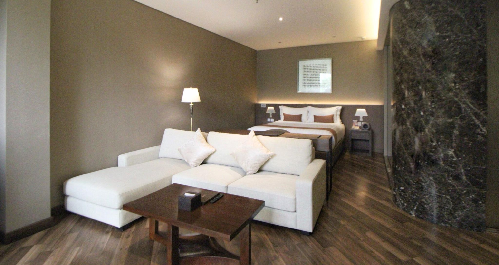 Modern hotel room at Ashley Hotel Group with a large bed