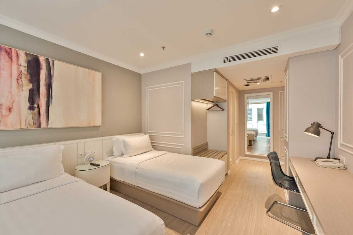 Interior view of a Deluxe Triple Room with three beds