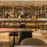 The warmly lit bar and dining area of Adele Dining & Bar