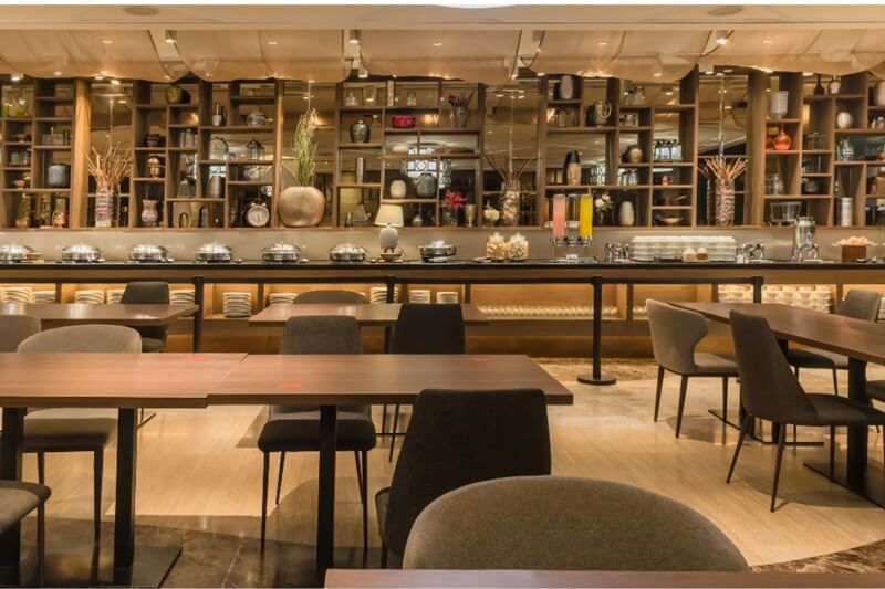 The warmly lit bar and dining area of Adele Dining & Bar
