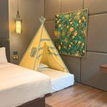 A modern Ashley hotel room with a bed and city view