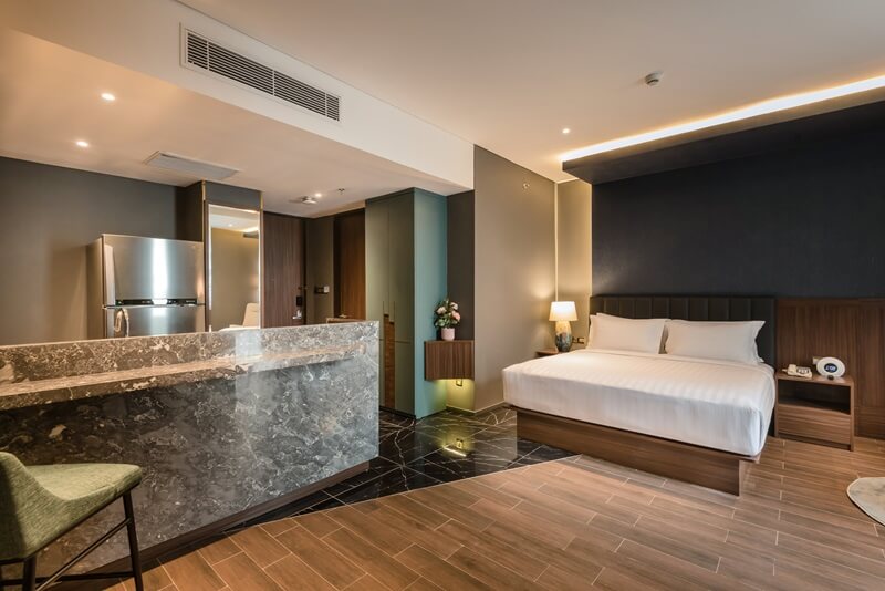 A bright Ashley Room with a bed and large window