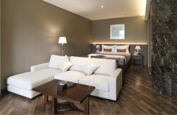 The Ashley Suite hotel room with a king bed and armchair