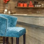 Bar area with modern seating and illuminated shelves