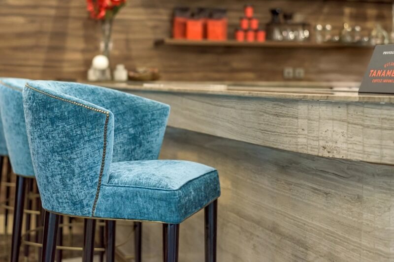 Bar area with modern seating and illuminated shelves