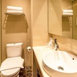 Modern hotel bathroom with a backlit mirror and vanity