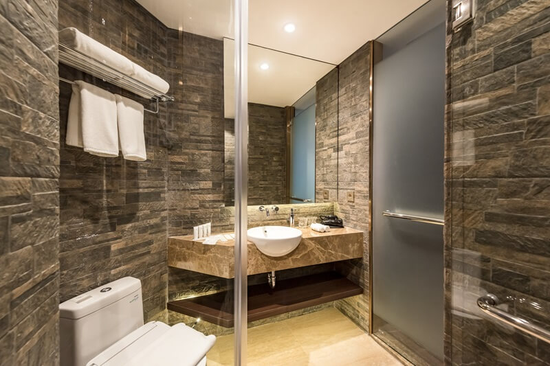 Ashley Hotel Group bathroom with a round backlit mirror