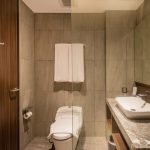 Ashley Hotel Group modern bathroom with backlit mirror