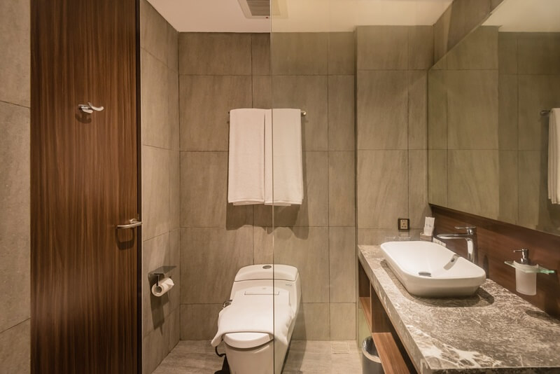 Ashley Hotel Group modern bathroom with backlit mirror