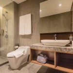 Ashley Hotel Group bathroom with a backlit round mirror