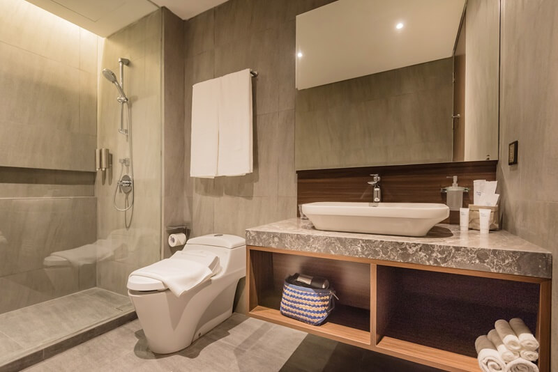 Ashley Hotel Group bathroom with a backlit round mirror