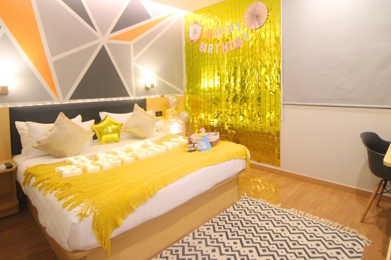 Hotel birthday room with balloons and bed decorations