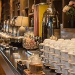 Modern hotel buffet area with food stations and seating