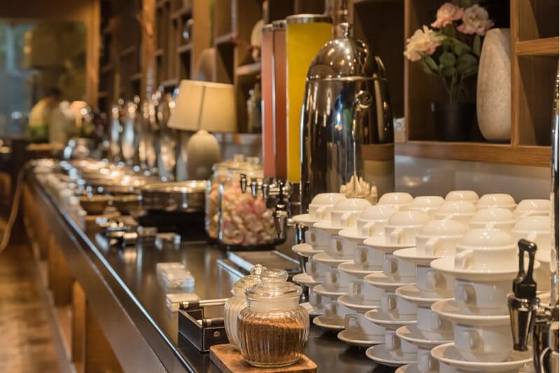 Modern hotel buffet area with food stations and seating