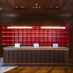 Modern hotel lobby with a reception desk and lounge area