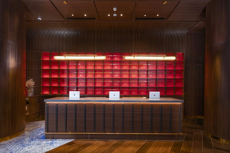 Modern hotel lobby with a reception desk and lounge area