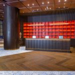 Modern hotel lobby with a reception desk and seating area