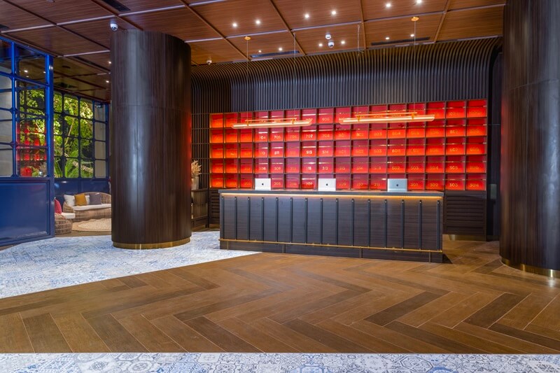 Modern hotel lobby with a reception desk and seating area