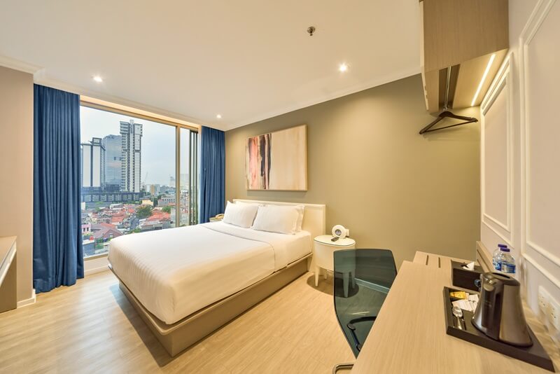 A modern deluxe double hotel room with a large bed