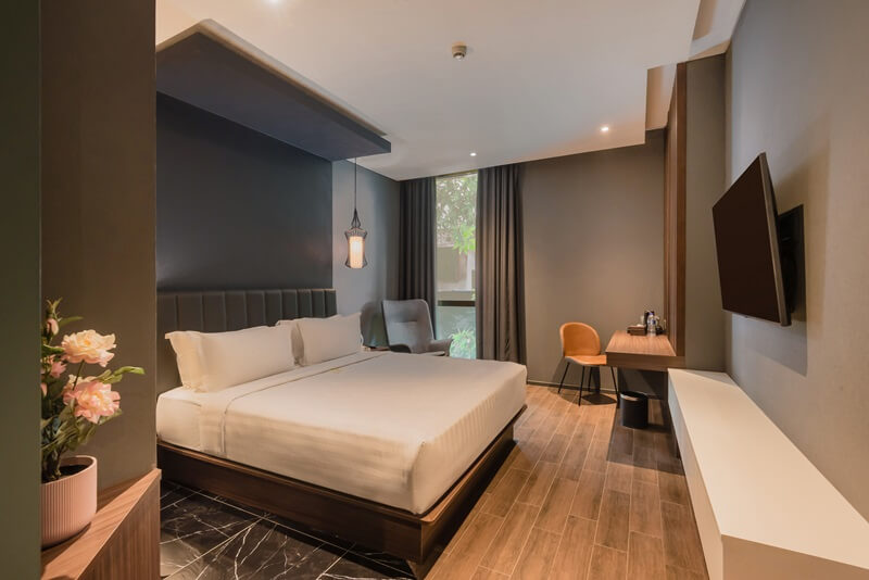 A modern deluxe double hotel room with a large bed