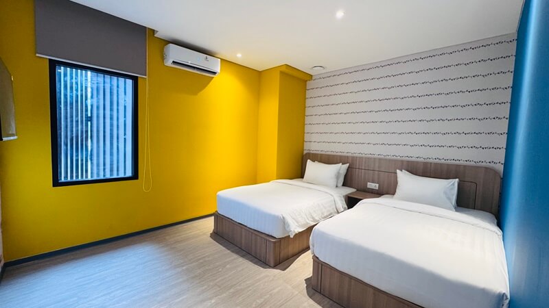A bright deluxe family room with two beds