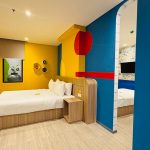 Deluxe family room with two beds and modern decor