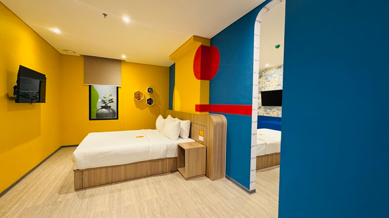 Deluxe family room with two beds and modern decor