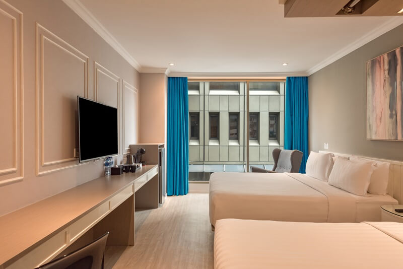 Deluxe triple hotel room with three single beds