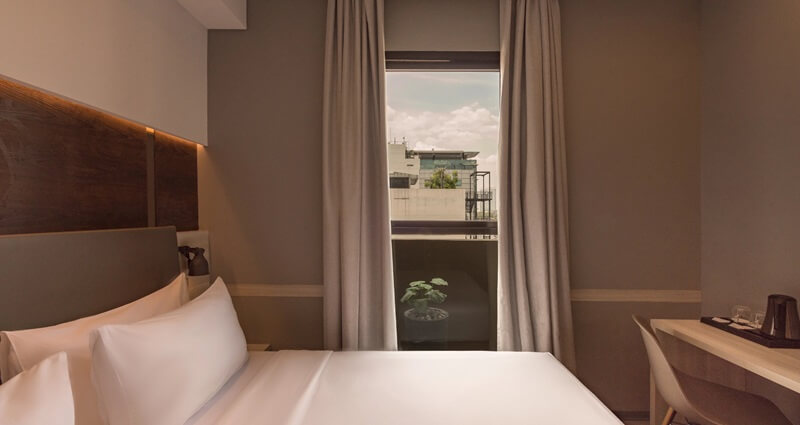 A modern Deluxe Double hotel room with a neatly made bed