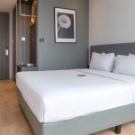 A modern Deluxe Double hotel room with a white bed