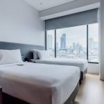 A modern Deluxe Twin hotel room with two beds