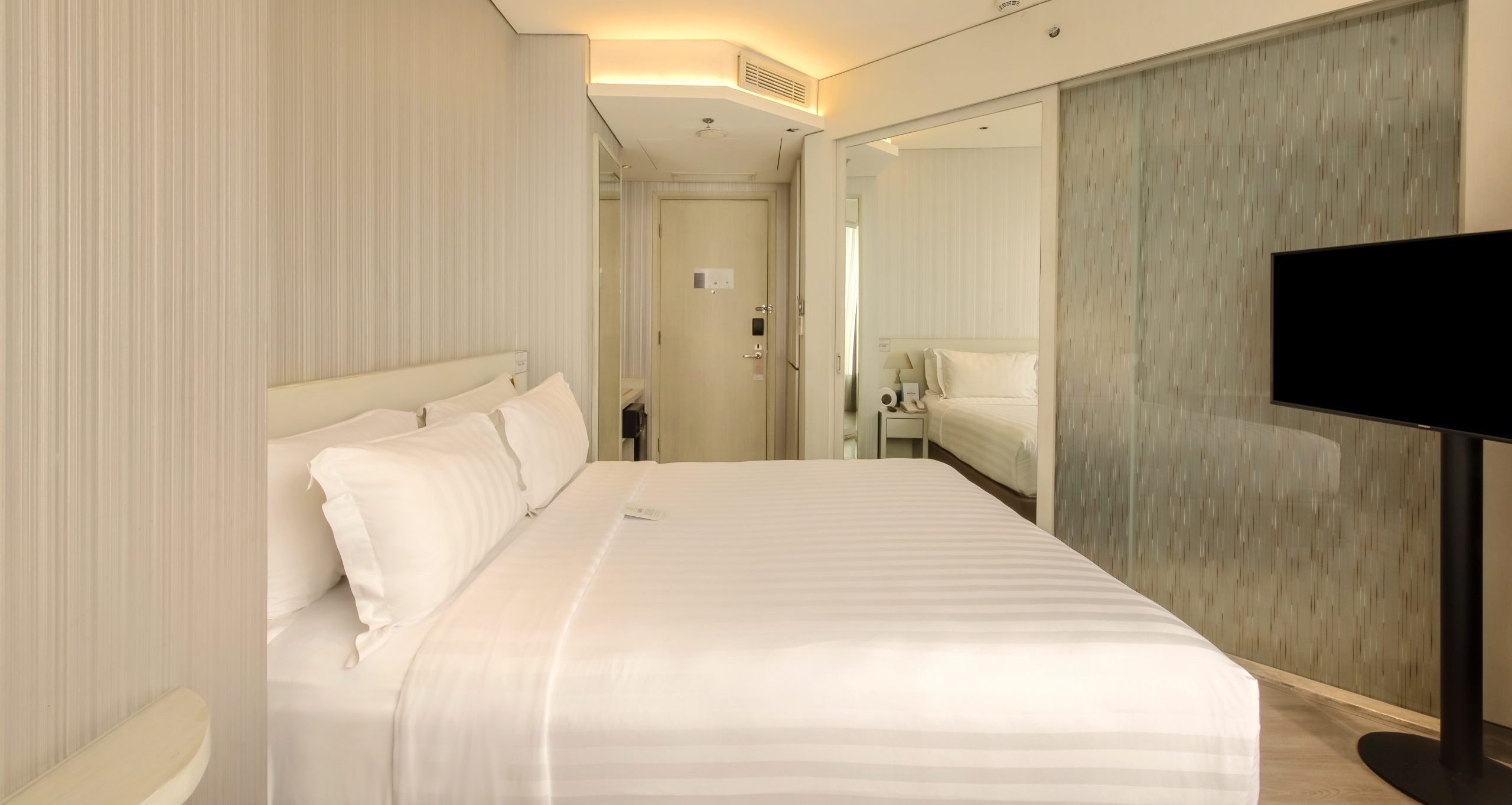 Ashley Hotel Group modern twin bedroom with city view