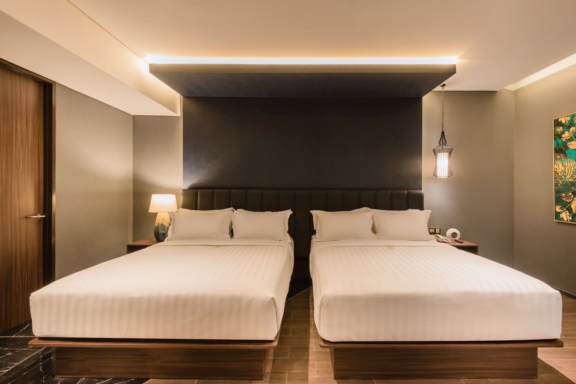 Modern family room with two beds at Ashley Hotel