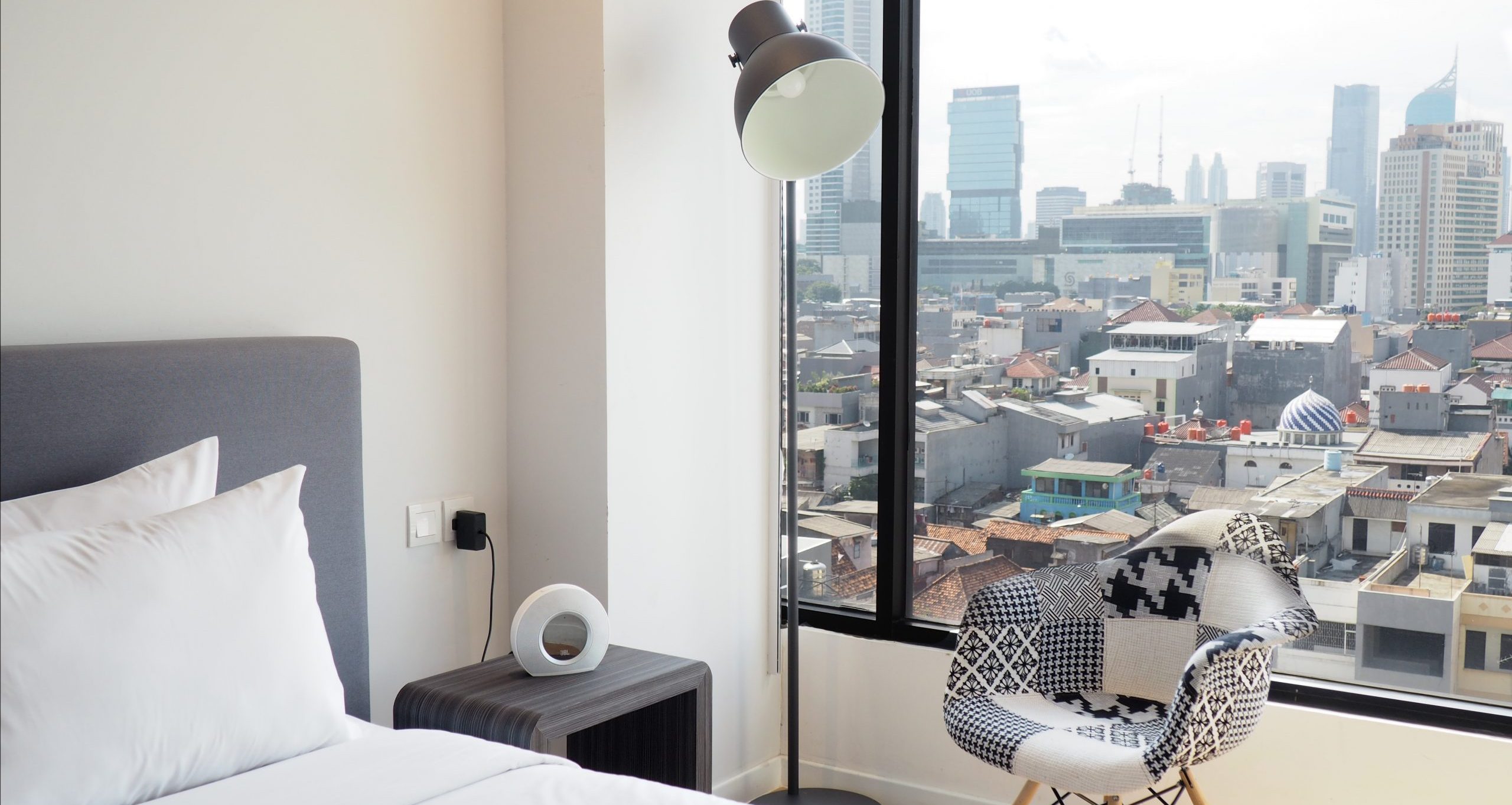 Executive hotel room with a bed and large window