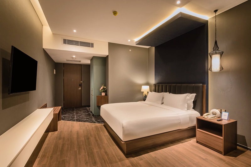 Modern hotel room with king bed and TV