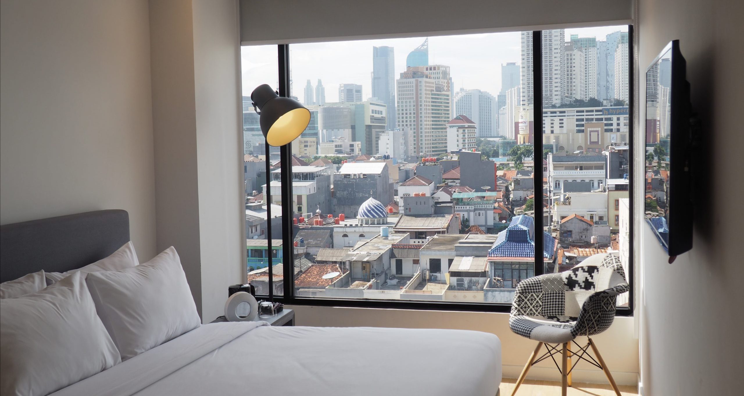 Executive hotel room with a large bed and city view