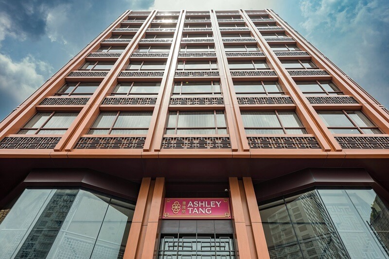 Facade of Ashley Tang hotel at dusk