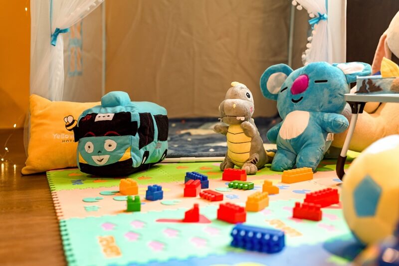 Colorful family room toys on a small white table and chairs