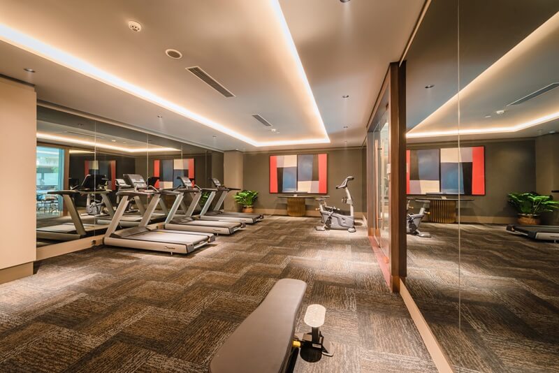 Modern fitness centre with treadmills and large windows