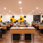 A modern function room with rows of chairs and a screen