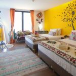 Colorful Mexican-themed girls' room with two twin beds
