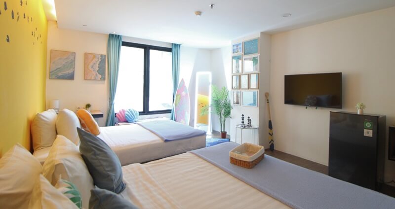 Girls room with a large surfer mural on the wall