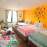 Bright girls' room with a tropical leaf wall mural