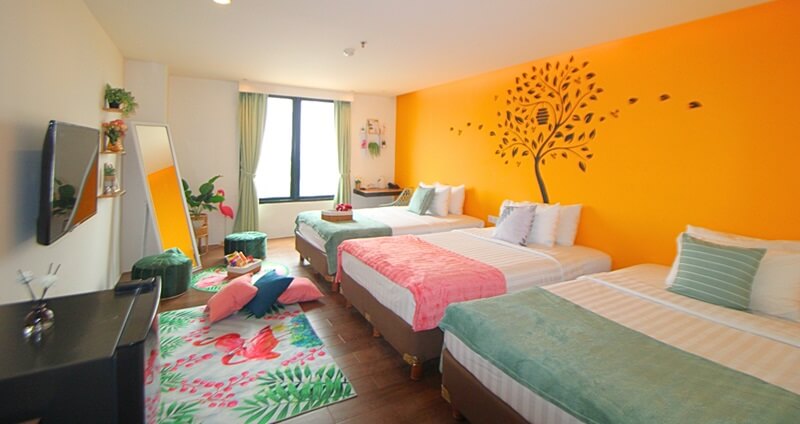 Bright girls' room with a tropical leaf wall mural