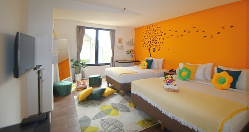 A bright yellow girls' room with two single beds