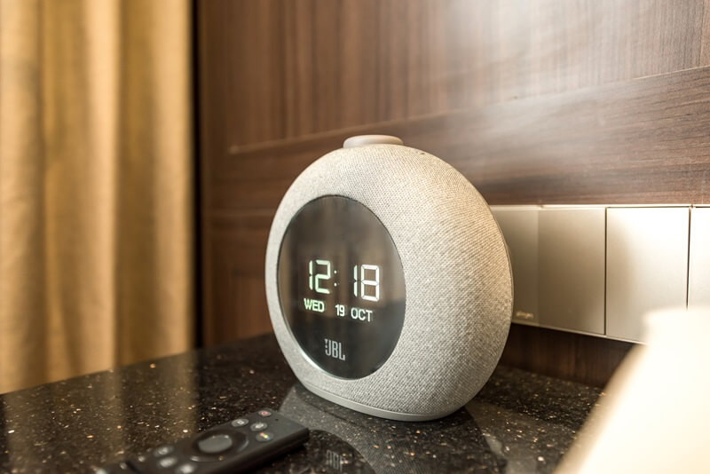 A black JBL Bluetooth speaker on a white surface