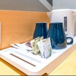 JUJT Room Amenities including a hairdryer, safe, and kettle