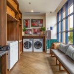Clean hotel laundry room with multiple washing machines