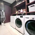 A clean, modern hotel laundry room with washing machines